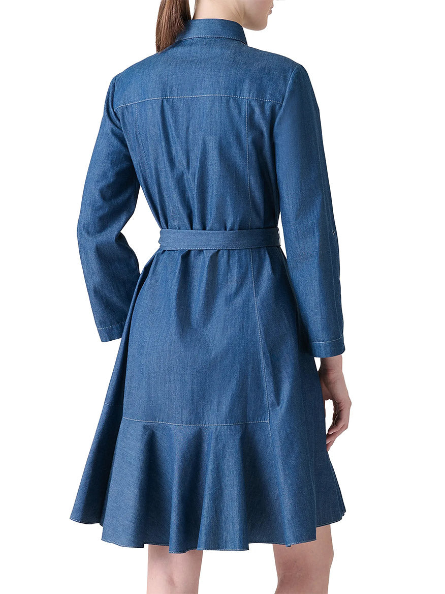 A woman is shown from behind wearing the Akris Punto Tie-Waist Denim Shirtdress in Medium Blue, featuring long sleeves, a belt, and an A-line silhouette.