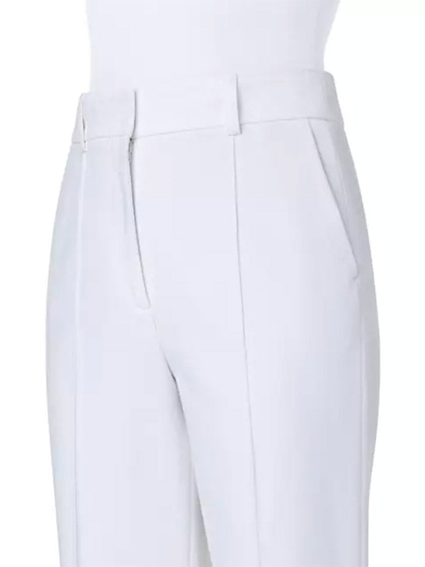 A mannequin wearing Akris Punto Ferry Tapered Ankle Pants in Cream with side slash pockets.