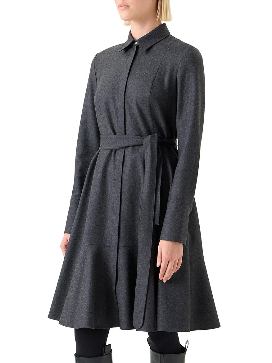 Someone wearing the Akris Punto Flannel Wool Belted Shirtdress in Charcoal, featuring long sleeves and a collared neckline, stands against a plain white background.