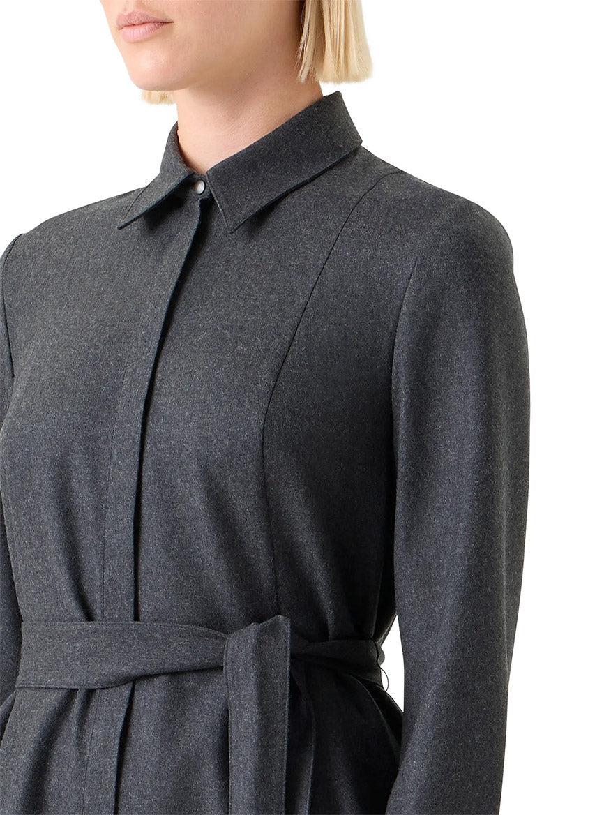 A woman models the Akris Punto Flannel Wool Belted Shirtdress in Charcoal, featuring a collared, long-sleeve design and cinched waist, shown from shoulders to mid-torso against a white background.