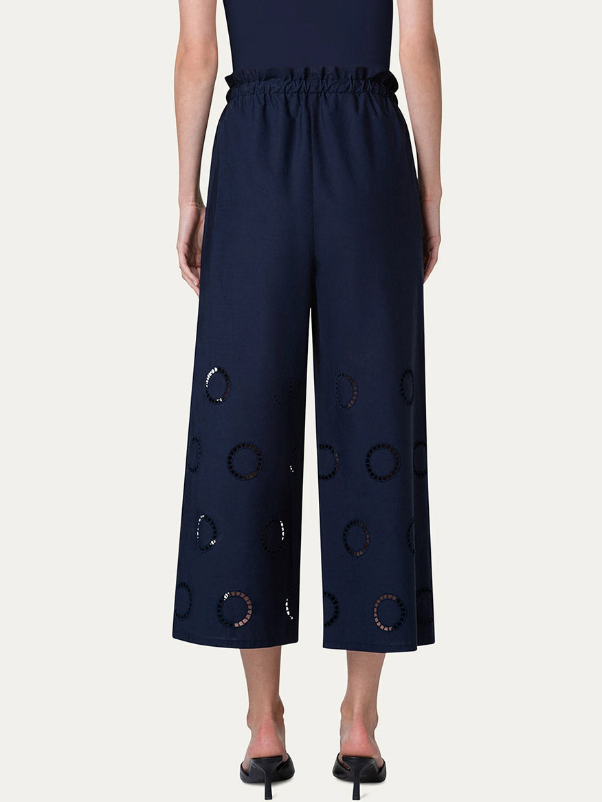 Woman wearing Akris Punto Frey Drawstring Pants with Circle Eyelets in Navy standing against a neutral background.