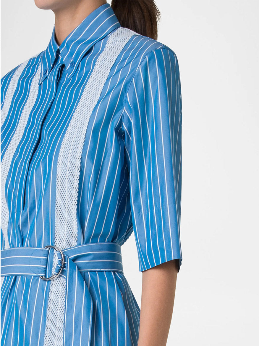 A woman models the Akris Punto Pajama Stripe Collared Dress in Medium Blue/Cream, featuring a D-ring self-belt and elbow-length sleeves, shown from the shoulders down.