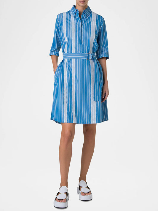 A person stands against a plain background wearing the Akris Punto Pajama Stripe Collared Dress in Medium Blue/Cream with a D-ring self-belt, styled with white platform sandals.