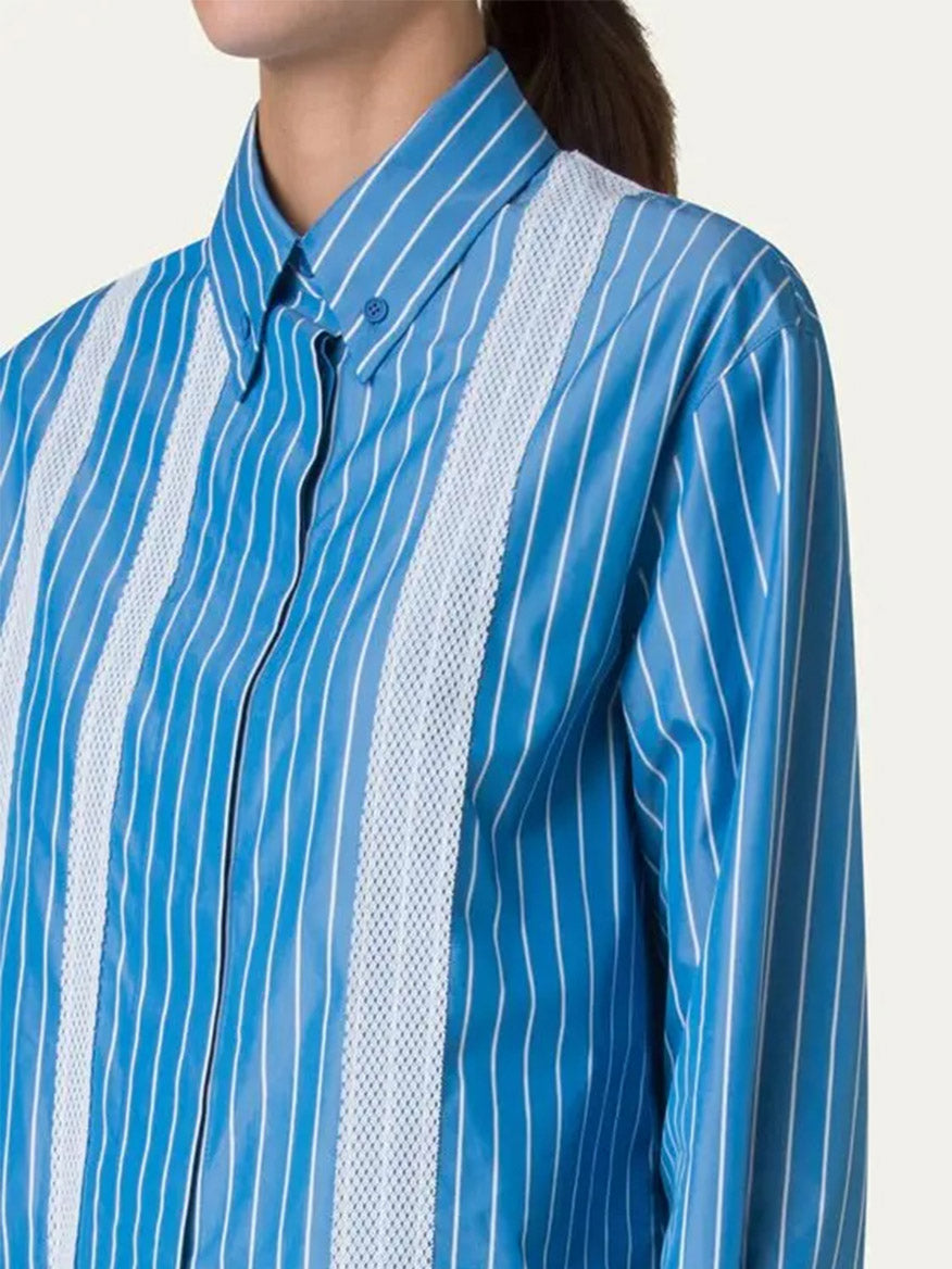 Person wearing the Akris Punto Pajama Stripe Boxy Collared Shirt in Medium Blue/Cream, featuring white pajama stripes and two white lace panels on the front.