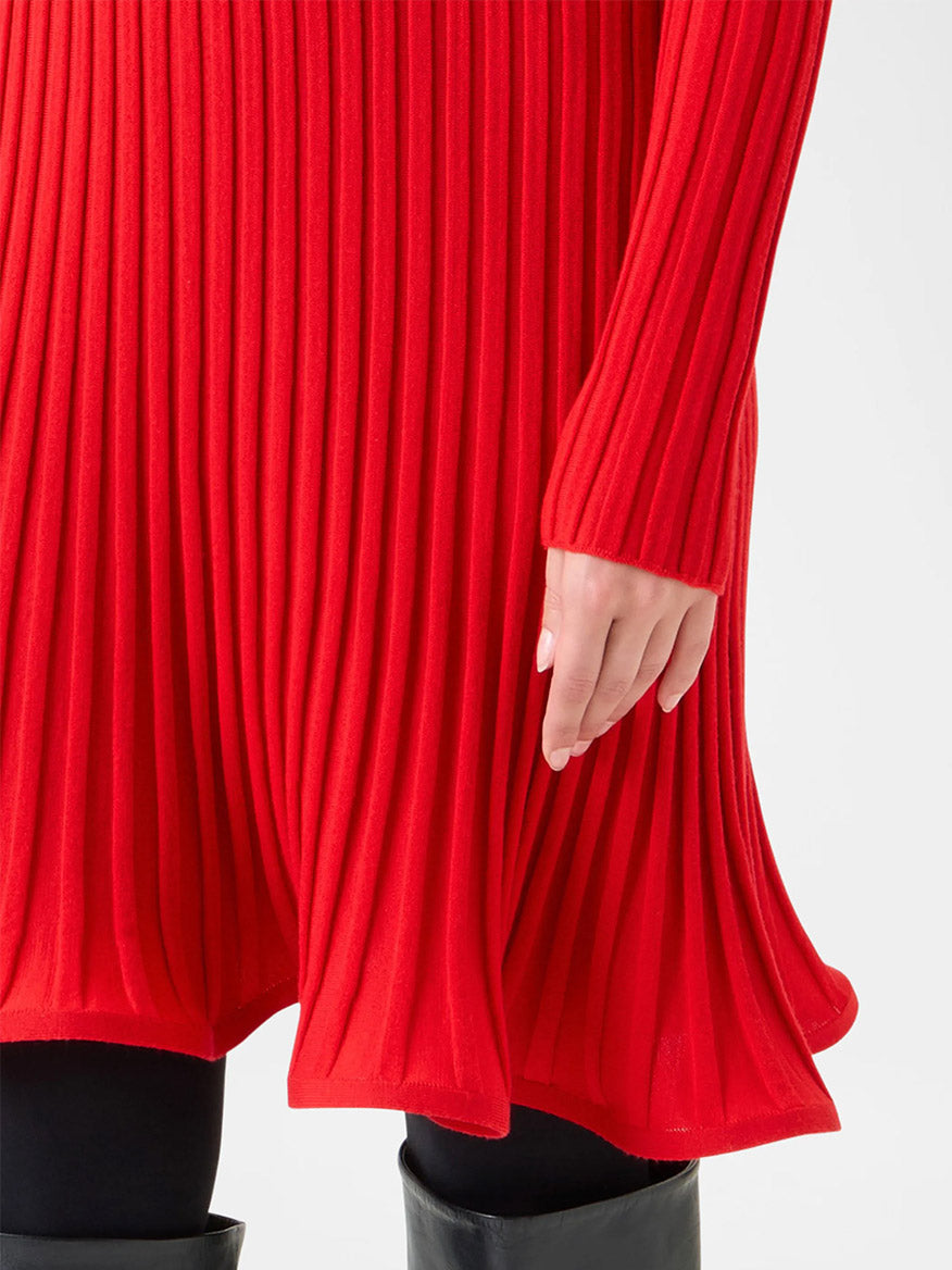 Wearing the Akris Punto Reverse Rib Fit & Flare Mini Dress in Vermillion with black leggings and black boots, shown from mid-thigh to hand.