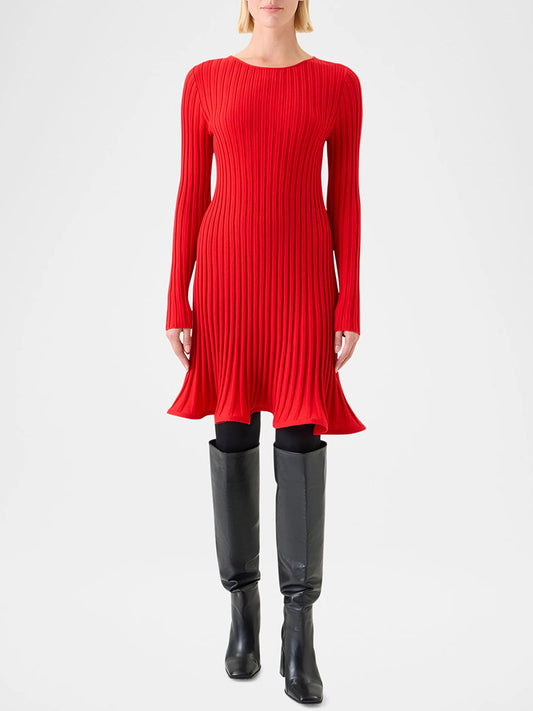 A person wearing the Akris Punto Reverse Rib Fit & Flare Mini Dress in Vermillion with black leggings and knee-high black boots stands against a plain background.