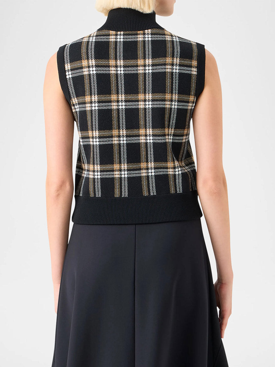 A person is shown from the back wearing the Akris Punto Sleeveless Plaid Jacquard Zip Sweater in Black/Cream/Camel with a black skirt.