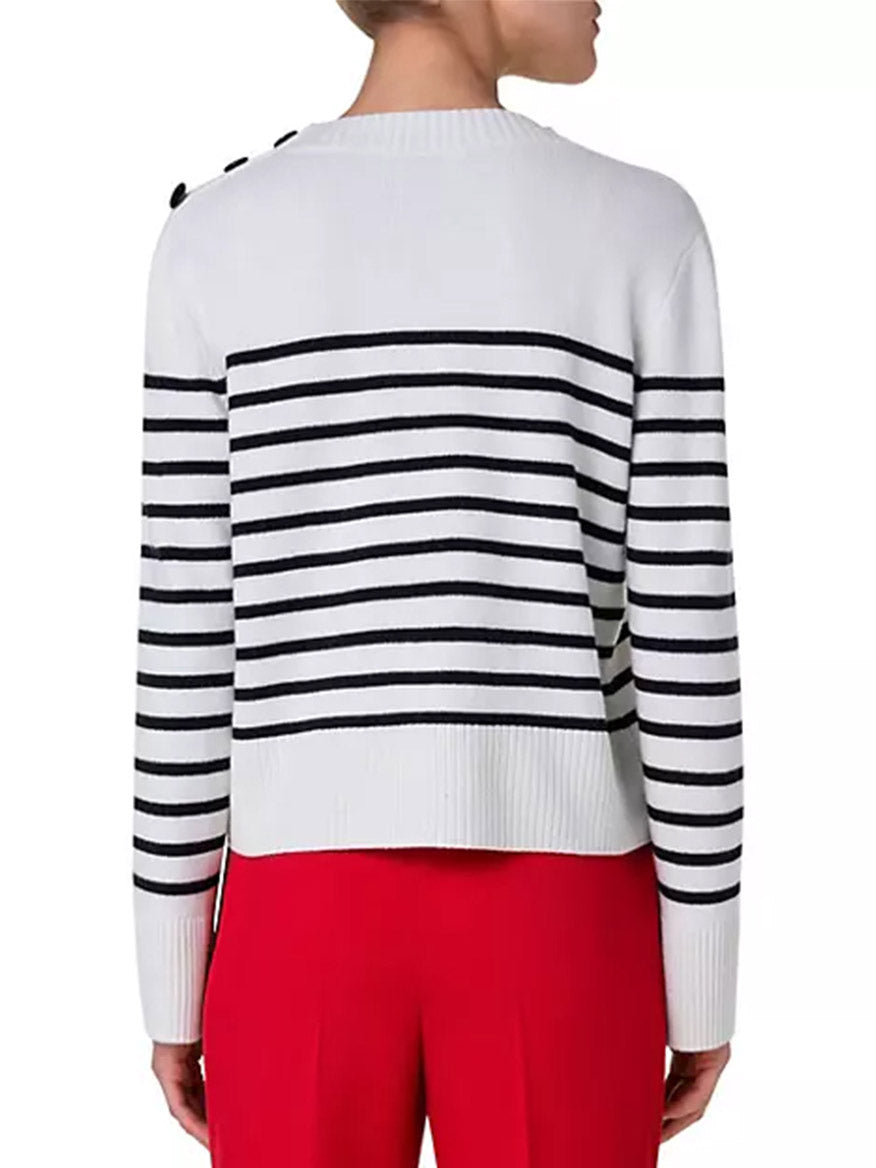 A woman wearing an Akris Punto Striped Crew Sweater With Snap Shoulder in Cream/Black cashmere blend sweater.