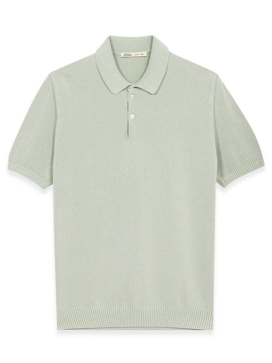 The Maurizio Baldassari Garment Dyed Cotton Polo in Aqua Sky features a honeycomb stitch, short sleeves, ribbed hem and cuffs, classic collar, and three-button placket, shown laid flat against a white background.