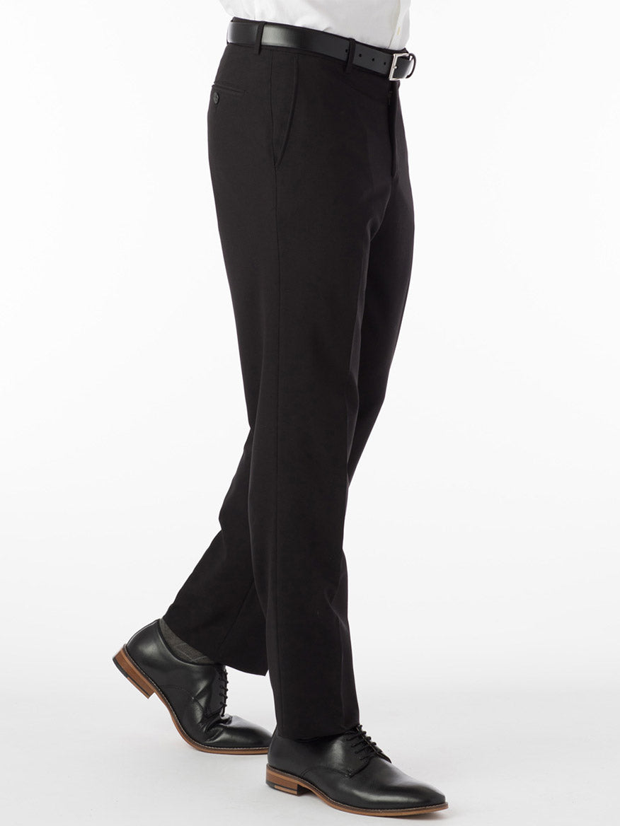 A person wears the Ballin Soho Comfort 'EZE' Commuter Bi-Stretch Gabardine Modern Flat Front Pant in Black with a black belt and dress shoes, standing against a plain white background.