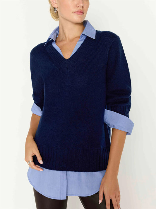 Woman wearing a Brochu Walker Arden Looker in Navy pre-layered sweater with a blue v-neck over a light blue collared shirt.