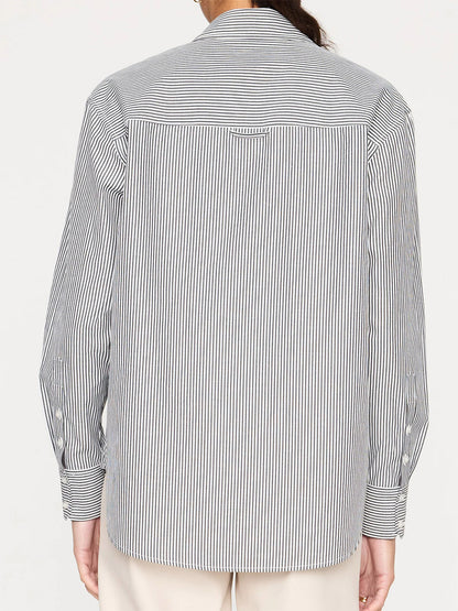 A person from behind wearing a Brochu Walker Everyday Shirt in Grey Stripe with a vertical pattern on the back and diagonal stripes on the sleeves in a relaxed fit.