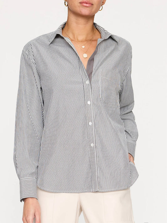 A person wearing a Brochu Walker Everyday Shirt in Grey Stripe with a relaxed fit and cream-colored trousers.