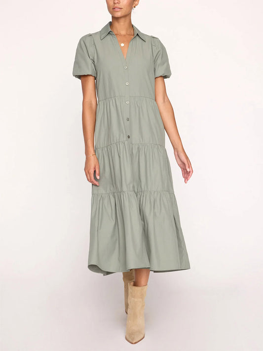A person wearing a Brochu Walker Havana Dress in Agave with short sleeves, paired with beige ankle boots. Only the body from neck to feet is visible.
