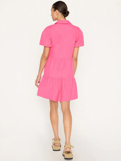 Woman in a Brochu Walker Havana Mini Dress in Hot Pink viewed from behind, standing in a neutral pose on a plain white background.