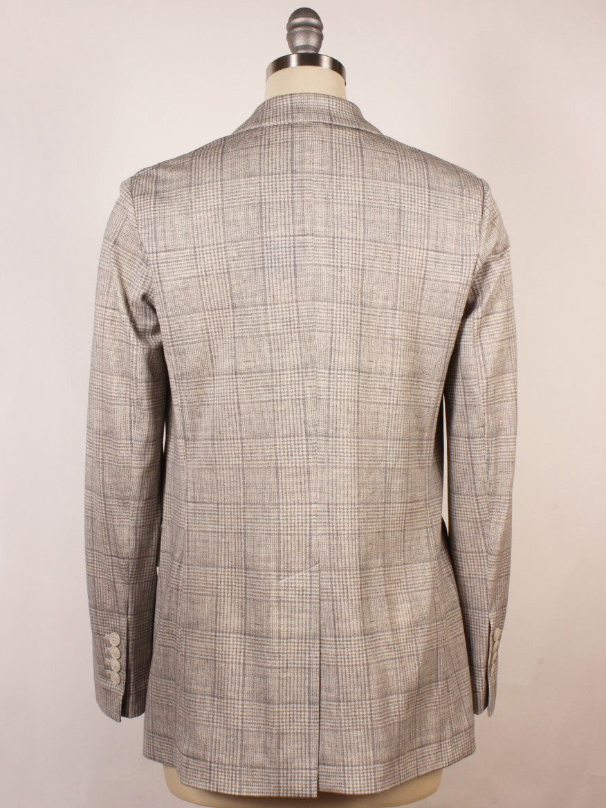 The Circolo 1901 Prince of Wales Double-Breasted Jacket in Grey, featuring peak lapels and sleeve buttons, is displayed on a dress form from the back, highlighting its classic plaid pattern and visible seam details.