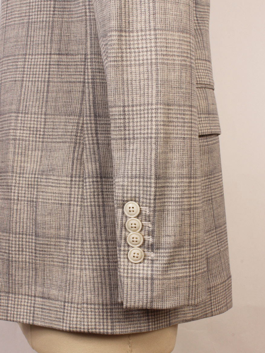Side view of the Circolo 1901 Prince of Wales Double-Breasted Jacket in grey, featuring a plaid pattern, four light buttons on the sleeve, flap pocket detailing, and visible peak lapels.