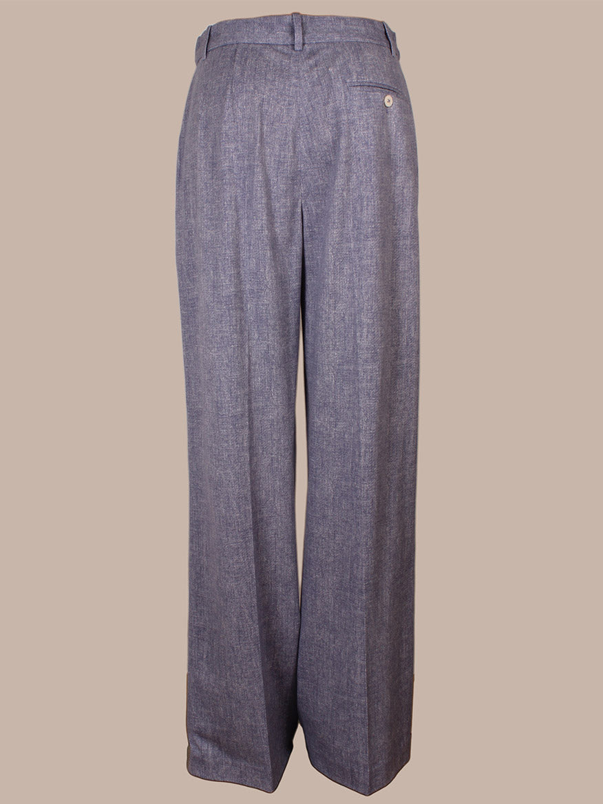 Back view of Circolo 1901 Herringbone Trouser in Dark Sky, featuring a high-waisted, wide-leg silhouette with a single back pocket and tab and bar closure, shown against a plain beige background.