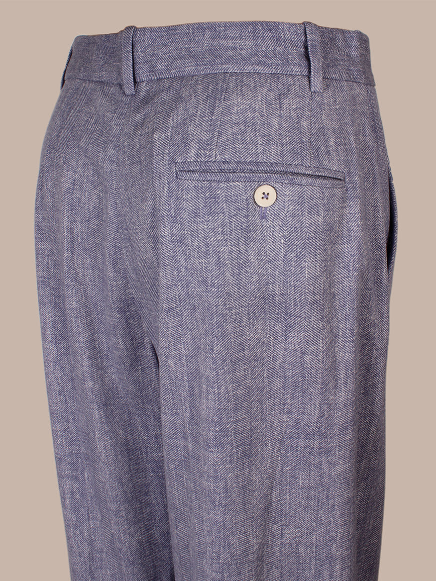 Close-up of the Circolo 1901 Herringbone Trouser in Dark Sky, highlighting the gray fabric, single welt pocket with button, belt loops at the waistband, and a classic tab and bar closure for a refined finish.