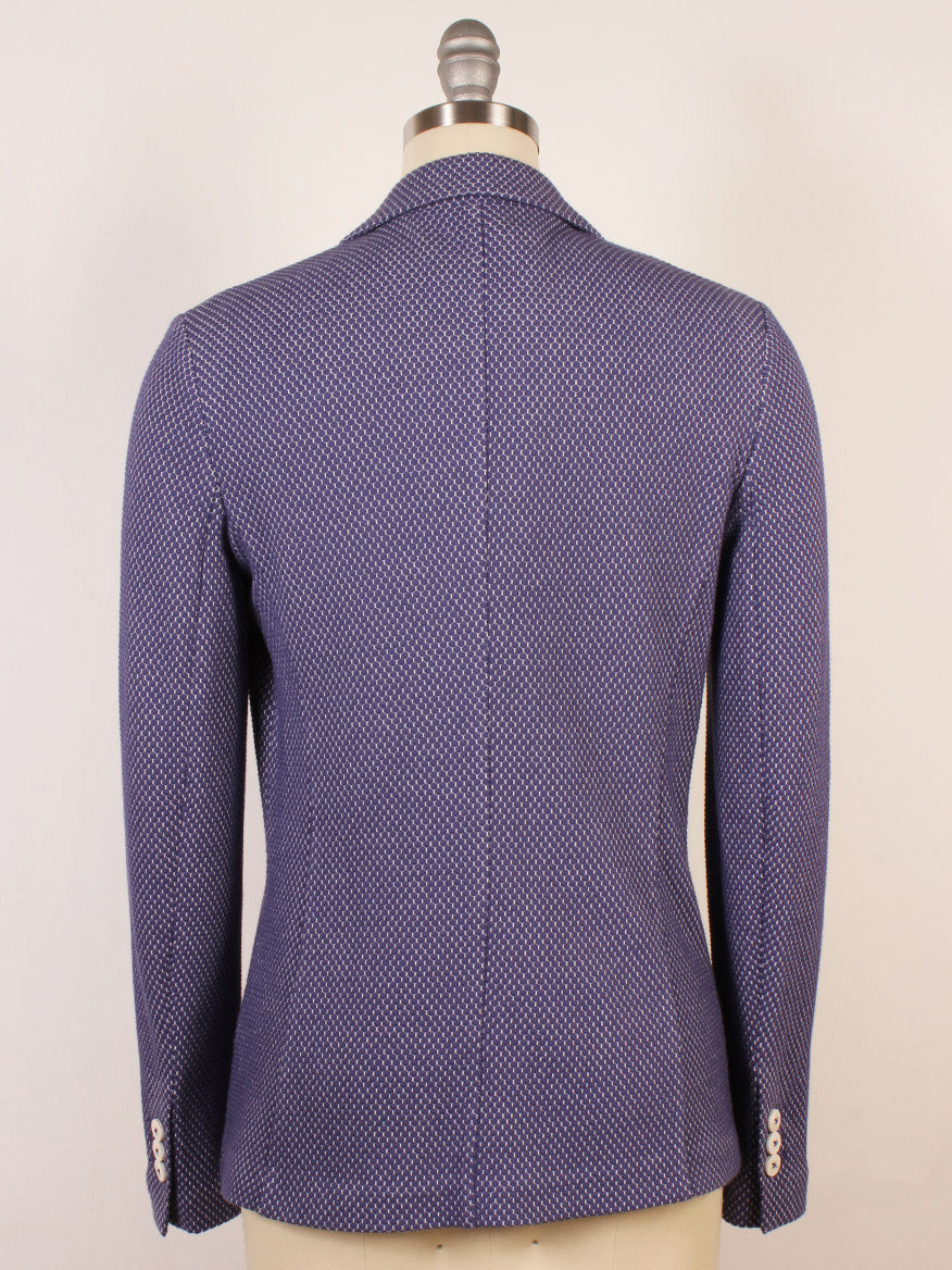 The Circolo 1901 2-Button Slim Honeycomb Jacket in Space Cobalt, shown from the back on a mannequin, features notch lapels, long sleeves, and light-colored cuff buttons.