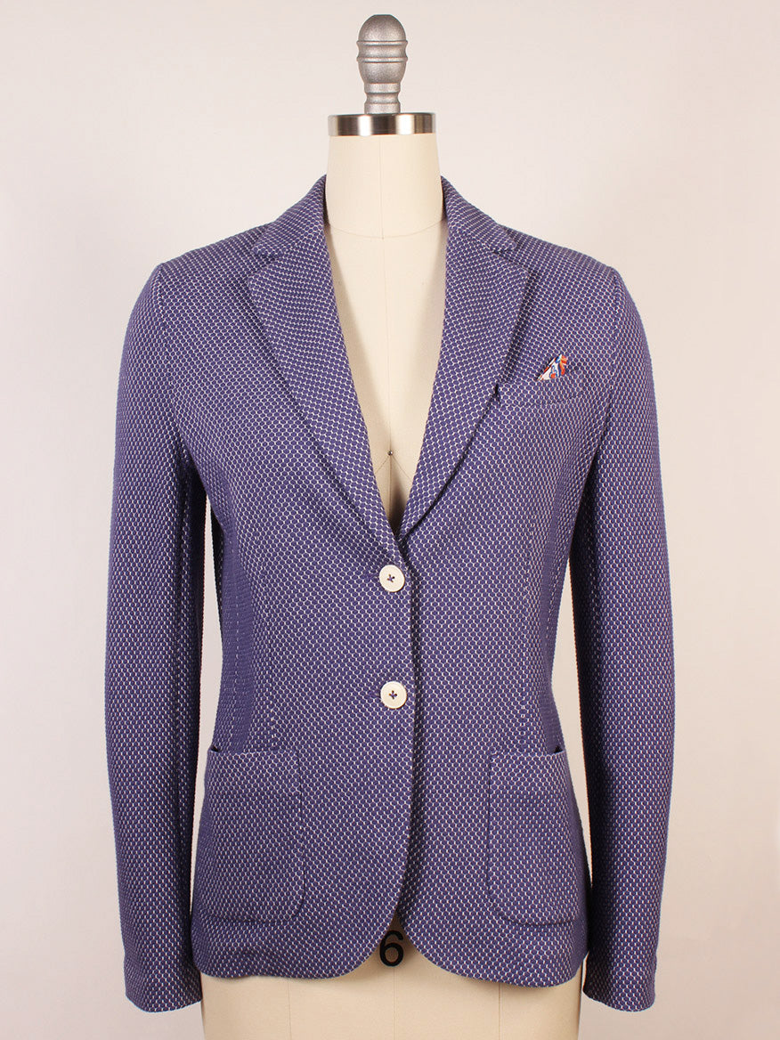 The Circolo 1901 2-Button Slim Honeycomb Jacket in Space Cobalt features a blue honeycomb texture, white buttons, notch lapels with a small pin, and two front pockets. Shown on a dress form against a plain background.