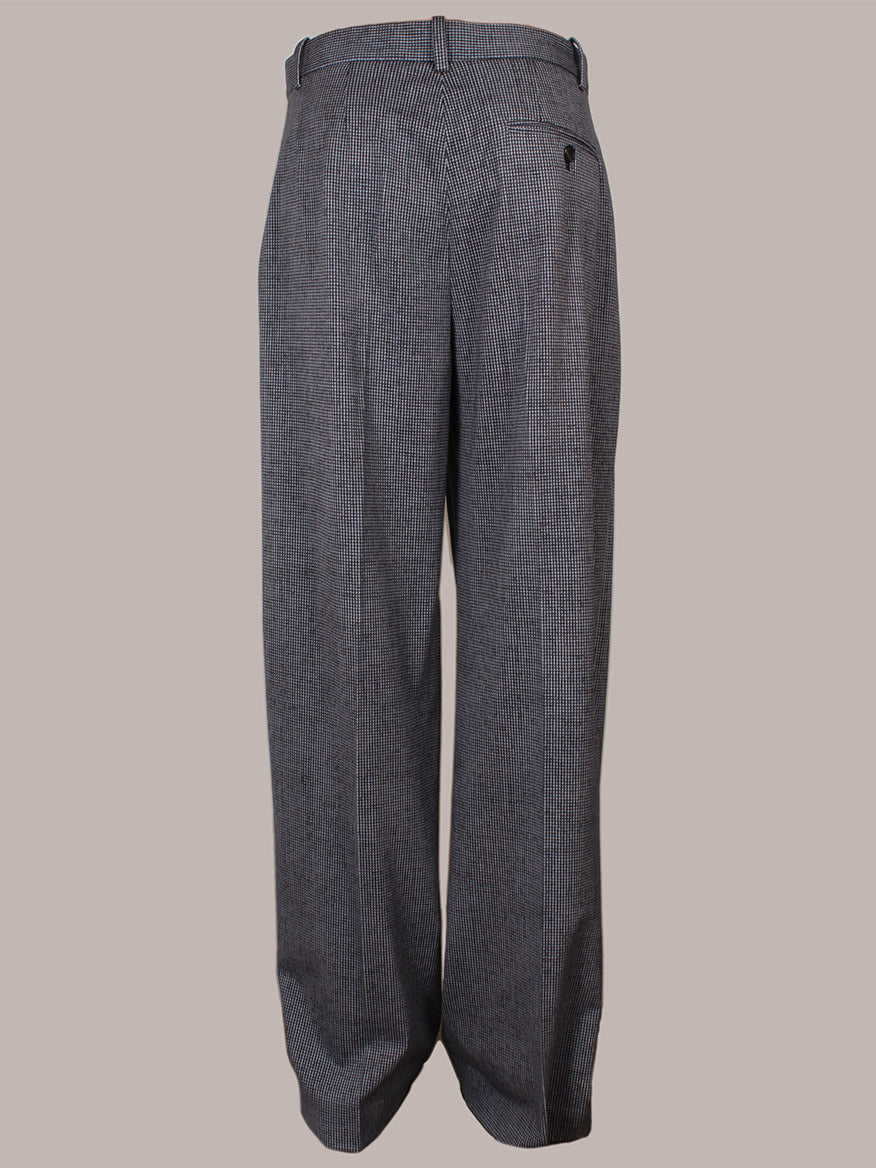 Circolo 1901 Mini Houndstooth Trouser in Blue features a high-waisted, wide-leg fit, subtle checkered pattern, tab and bar closure, belt loops, and a single buttoned back pocket.