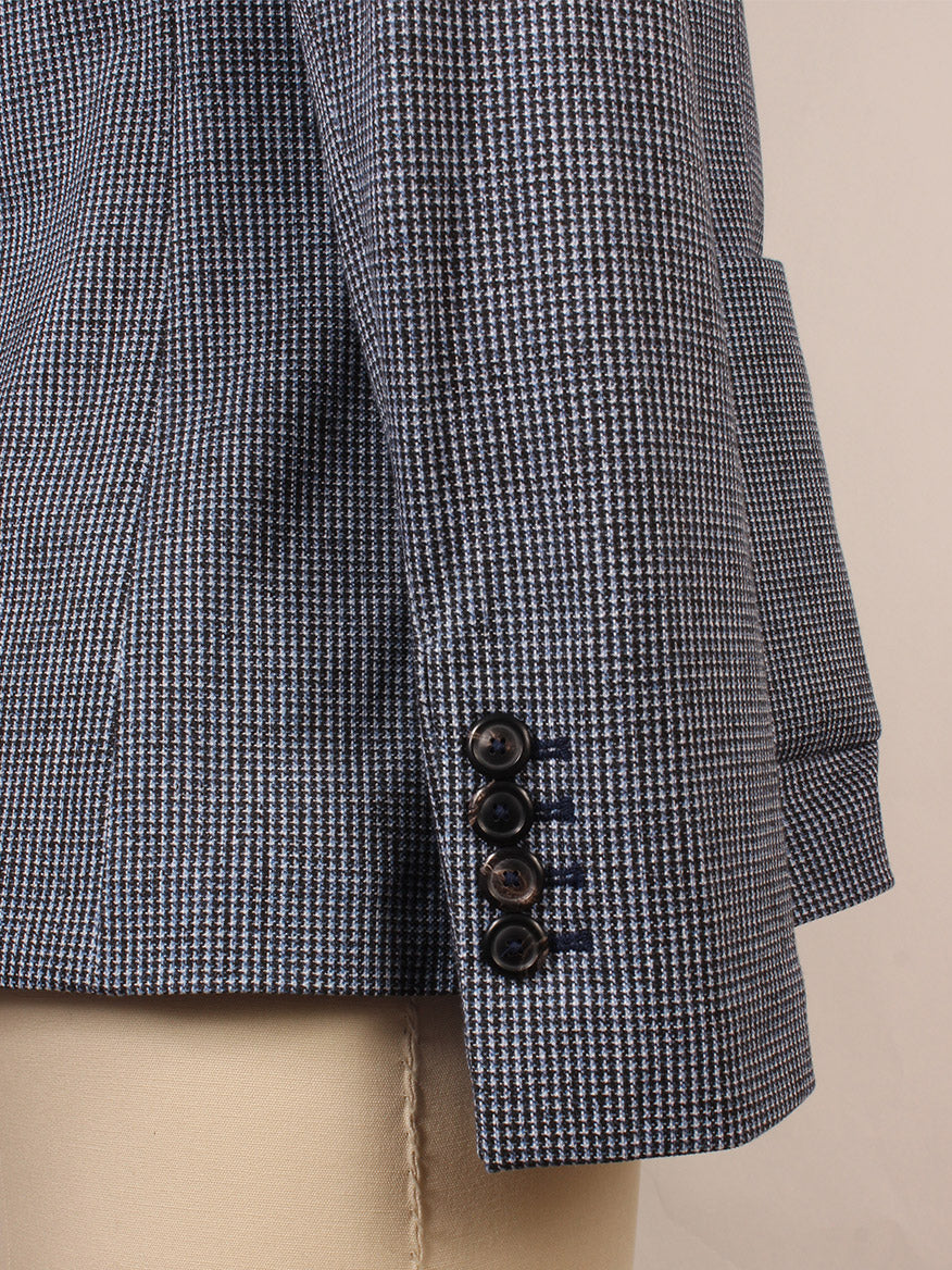 Close-up of the Circolo 1901 Slim Fit Mini Houndstooth Jacket in Blue, featuring a slim sleeve with four black cuff buttons and notch lapels, displayed on a beige mannequin.