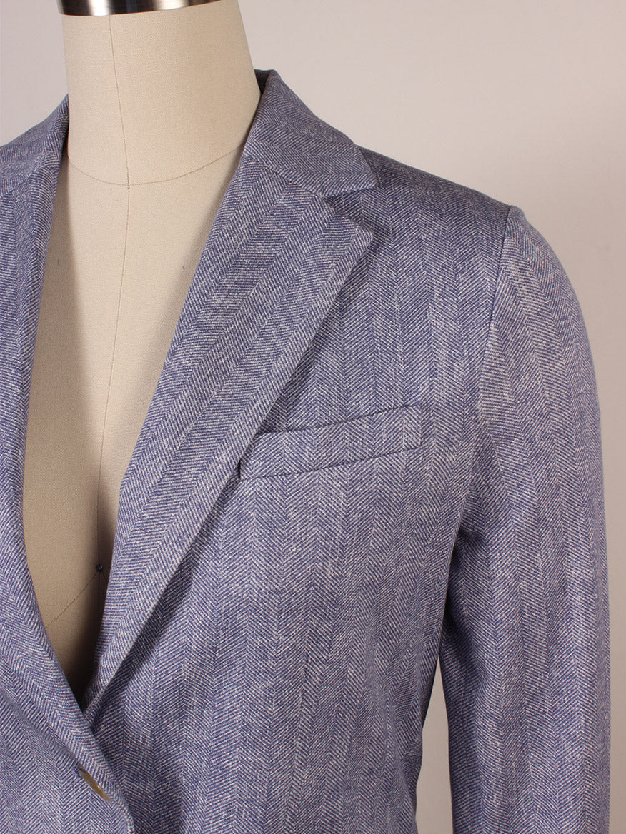 Close-up of the Circolo 1901 1-Button Slim Herringbone Jacket in Dark Sky on a dress form, highlighting its notch lapels, chest pocket, and part of the sleeve under soft dark sky lighting.