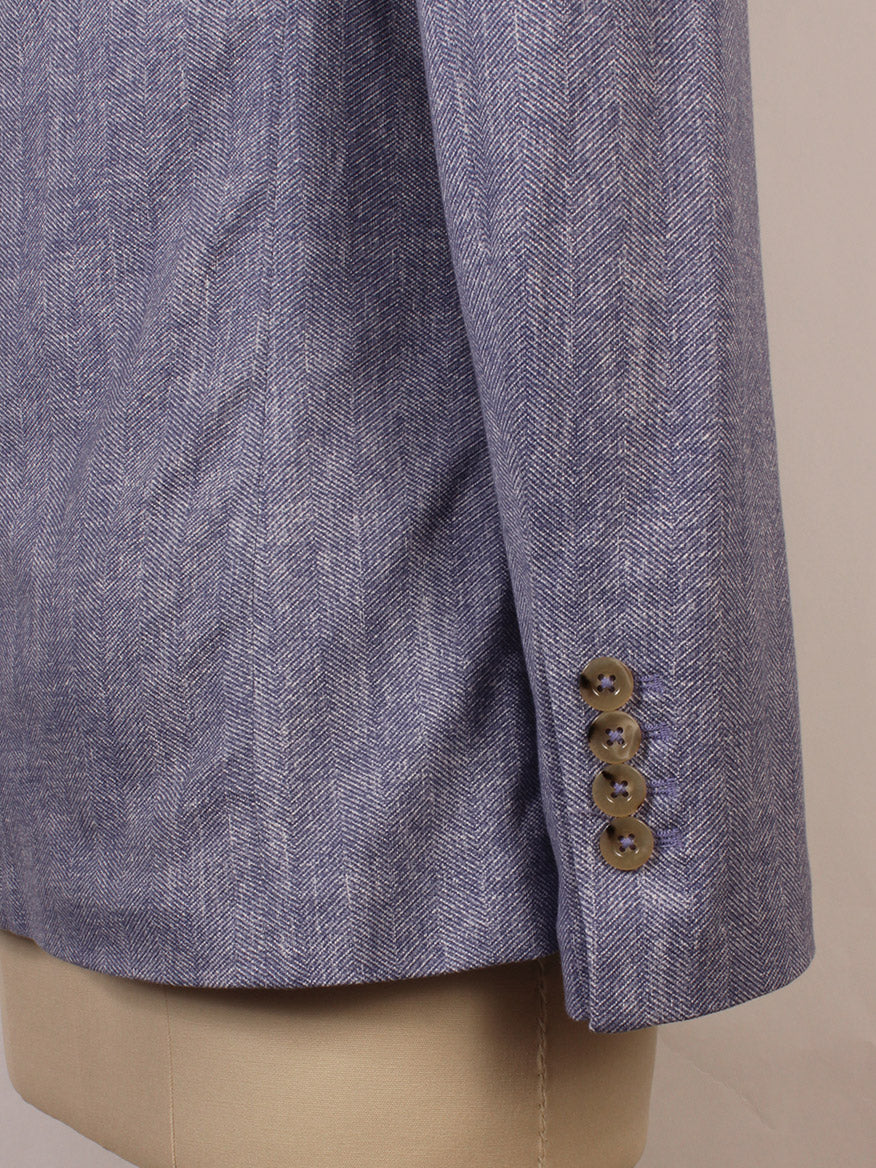 Close-up of Circolo 1901 1-Button Slim Herringbone Jacket in Dark Sky, featuring four brown cuff buttons, notch lapels, and front jetted pockets for a refined, stylish look. Shown on a mannequin.