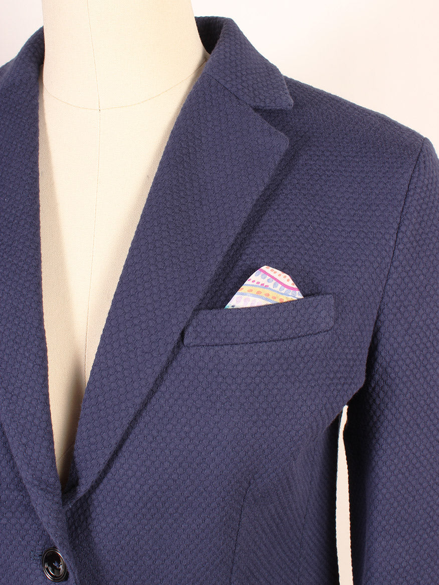 Close-up of the Circolo 1901 Honeycomb Short Jacket in Navy on a mannequin, highlighting its notched lapels and colorful pocket square in the breast pocket, showcasing its sophisticated honeycomb weave.