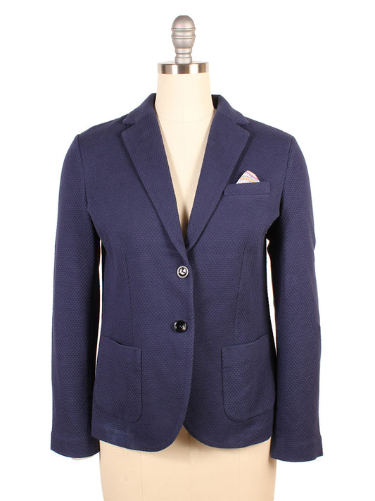 The Circolo 1901 Honeycomb Short Jacket in Navy, featuring notched lapels, two buttons, and a pocket square, is elegantly displayed on a mannequin.