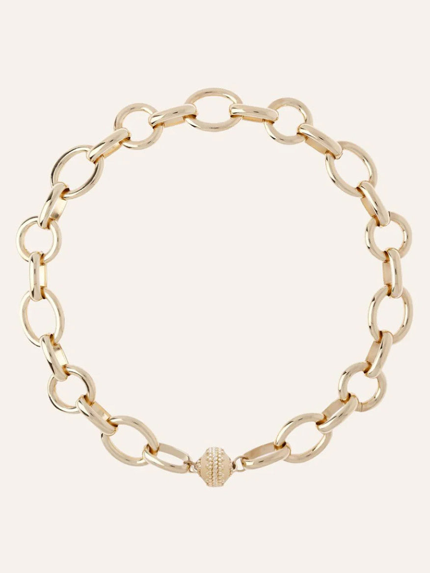 The Clara Williams Gold Coast Necklace, crafted in 14K yellow gold with large oval links and a decorative ClaraClasp, is shown on a plain background.