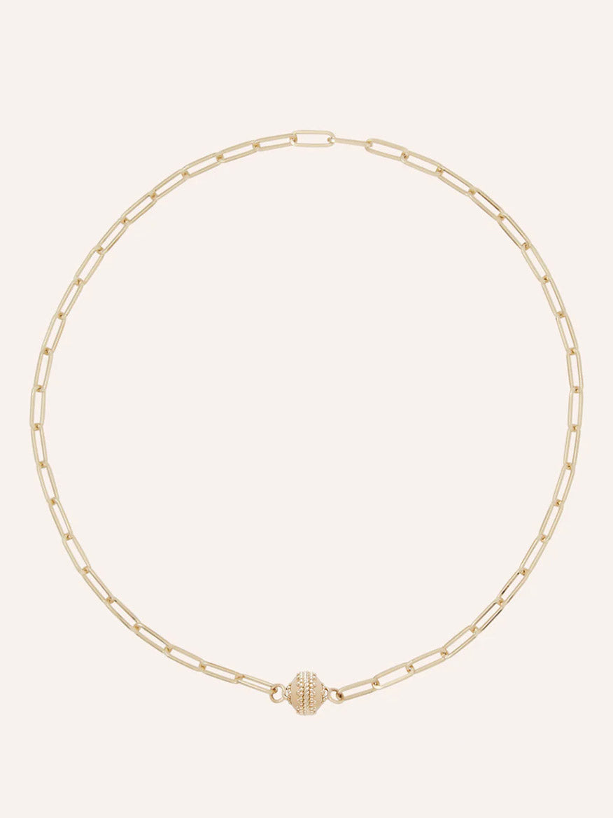 The Clara Williams Kingsbury Gold Mini Necklace features elongated 14K yellow gold paperclip links and a textured ClaraClasp centerpiece, and is displayed on a plain light background.