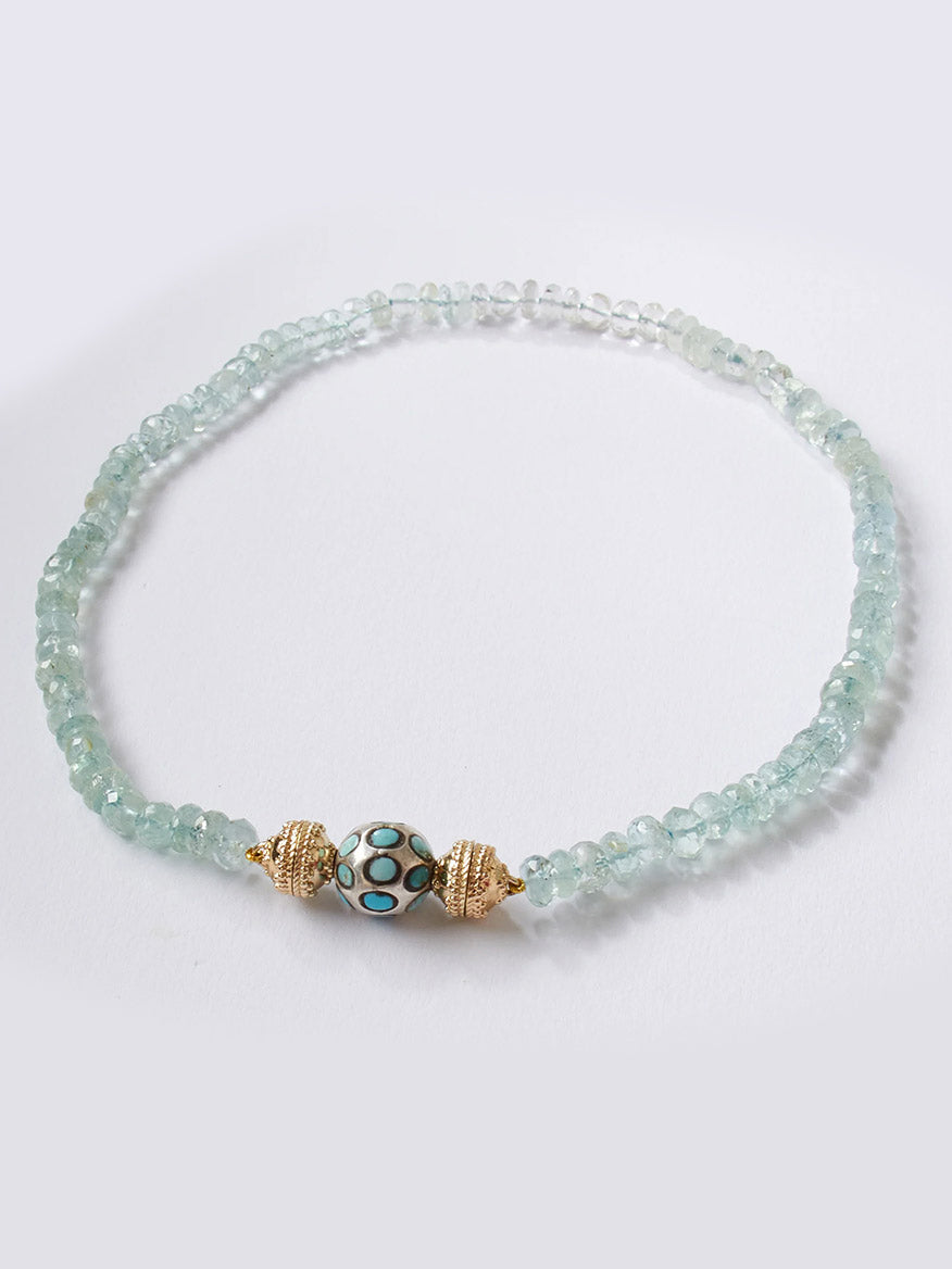 Adorn your wrist with the Clara Williams Turquoise and Sterling Silver Mini Centerpiece—an elegant bracelet featuring light green translucent beads, a central round bead detailed with turquoise and black dots, flanked by two gold-toned accents, and finished with a sterling silver Mini Magnetic ClaraClasp for effortless elegance.
