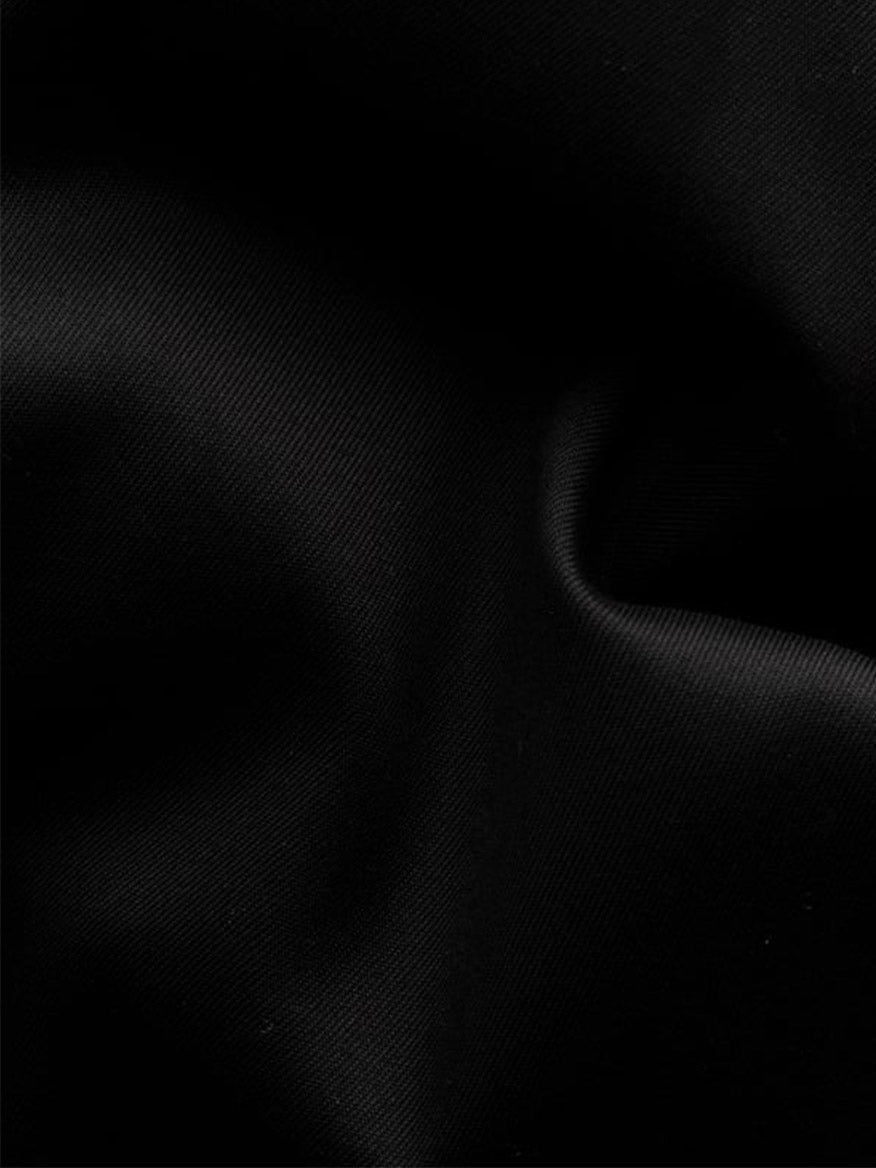 Close-up of the Eton Slim Fit Fine Striped Bib Evening Shirt in Black, highlighting its elegant French cuffs, black fabric with visible folds, and subtle textured stripes.