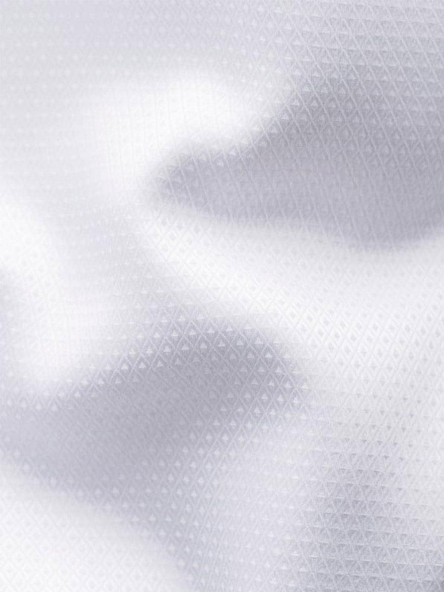 Close-up of the Eton Slim Fit Fly Front Evening Dobby Shirt in White, crafted from organic cotton with a subtle diamond pattern and soft folds—ideal for an elegant evening look.