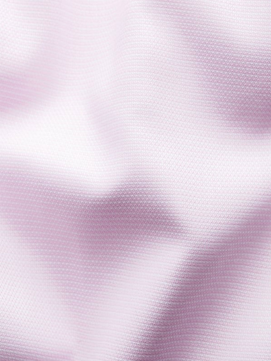 Close-up of the Eton Slim Fit Semi Solid Piping Details Shirt in Pink, showcasing light pink Oxford cotton with a visible weave and gentle folds—ideal for a modern, tailored look.