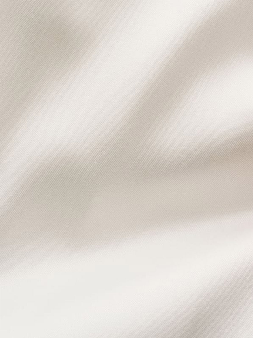 Close-up of smooth, off-white Eton Contemporary Fit Solid Signature Twill Dress Shirt fabric with soft shadows and gentle folds.