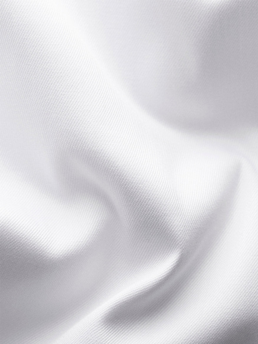 Close-up of smooth, white Eton Slim Fit Signature Twill Dress Shirt fabric with subtle texture and grey details—perfect for a wrinkle-resistant, stylish fit.