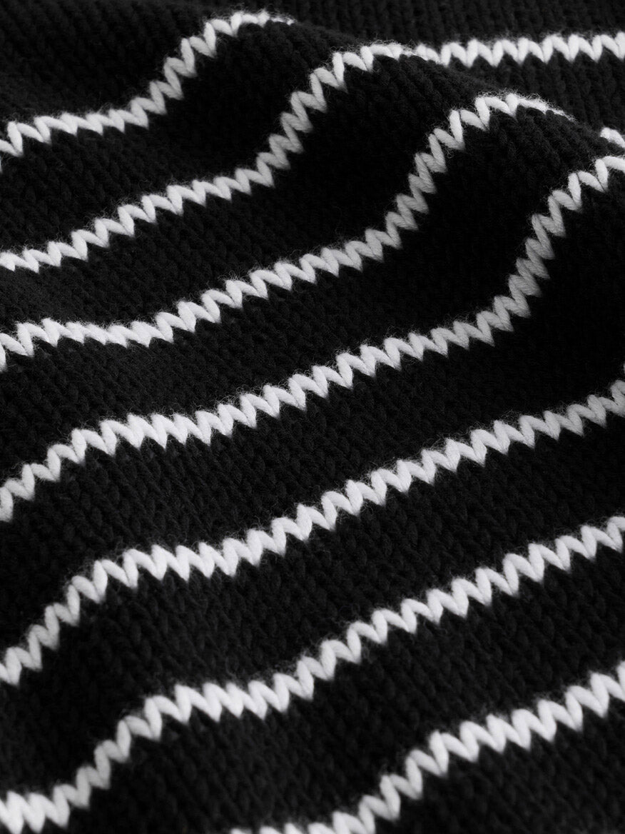 The Eileen Fisher Peruvian Organic Cotton Cord Crew Neck Top in Black/White showcases a black textured fabric accented with raised, wavy white lines running horizontally in a repeating pattern. Made from soft organic cotton and Fair Trade Certified, this boxy fit top features a classic crew neck for effortless style and comfort.