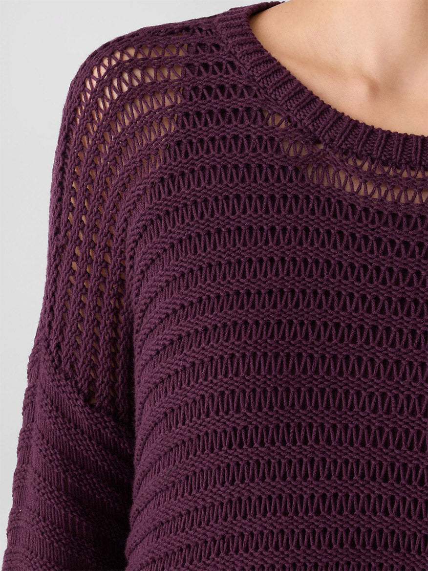 Close-up of a person wearing the Eileen Fisher Peruvian Organic Cotton Cord Crew Neck Top in Blackberry, featuring a boxy fit, round neckline, and textured horizontal patterns.