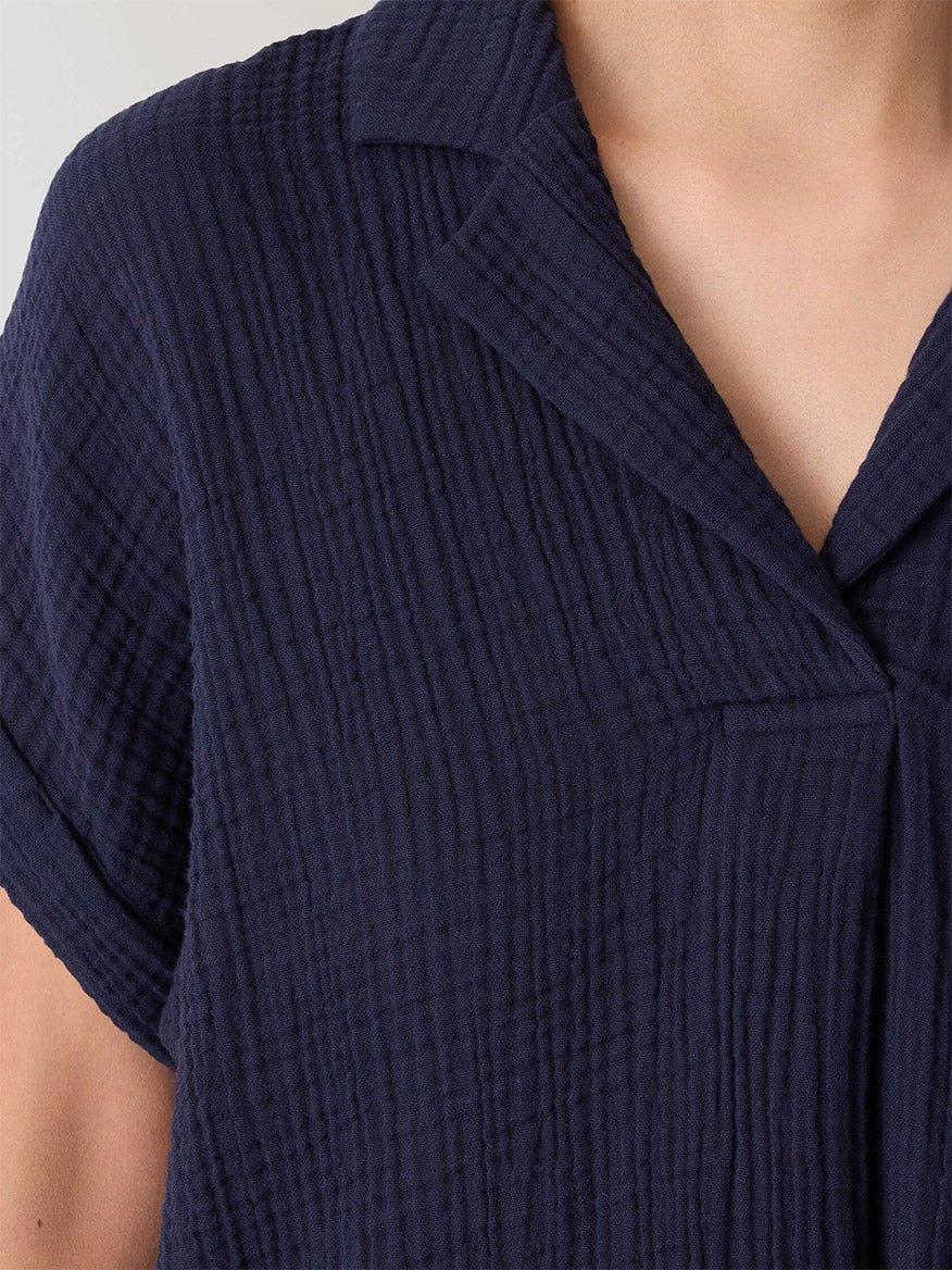 Close-up of a person wearing the Eileen Fisher Organic Cotton Lofty Gauze Notch Collar Top in Ink, featuring short sleeves and a boxy fit.