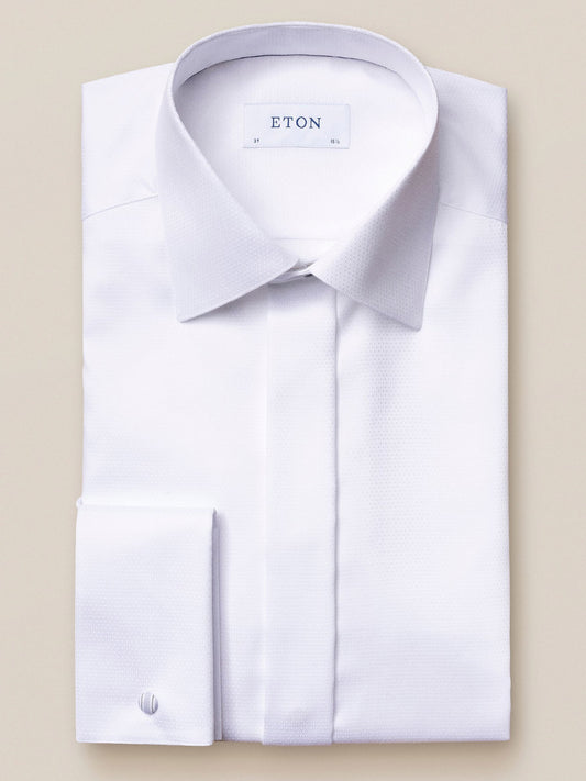 Folded Eton White Dobby Formal Shirt with a pointed collar and French cuffs, made from luxurious dobby fabric and labeled "Eton" on the inner collar.
