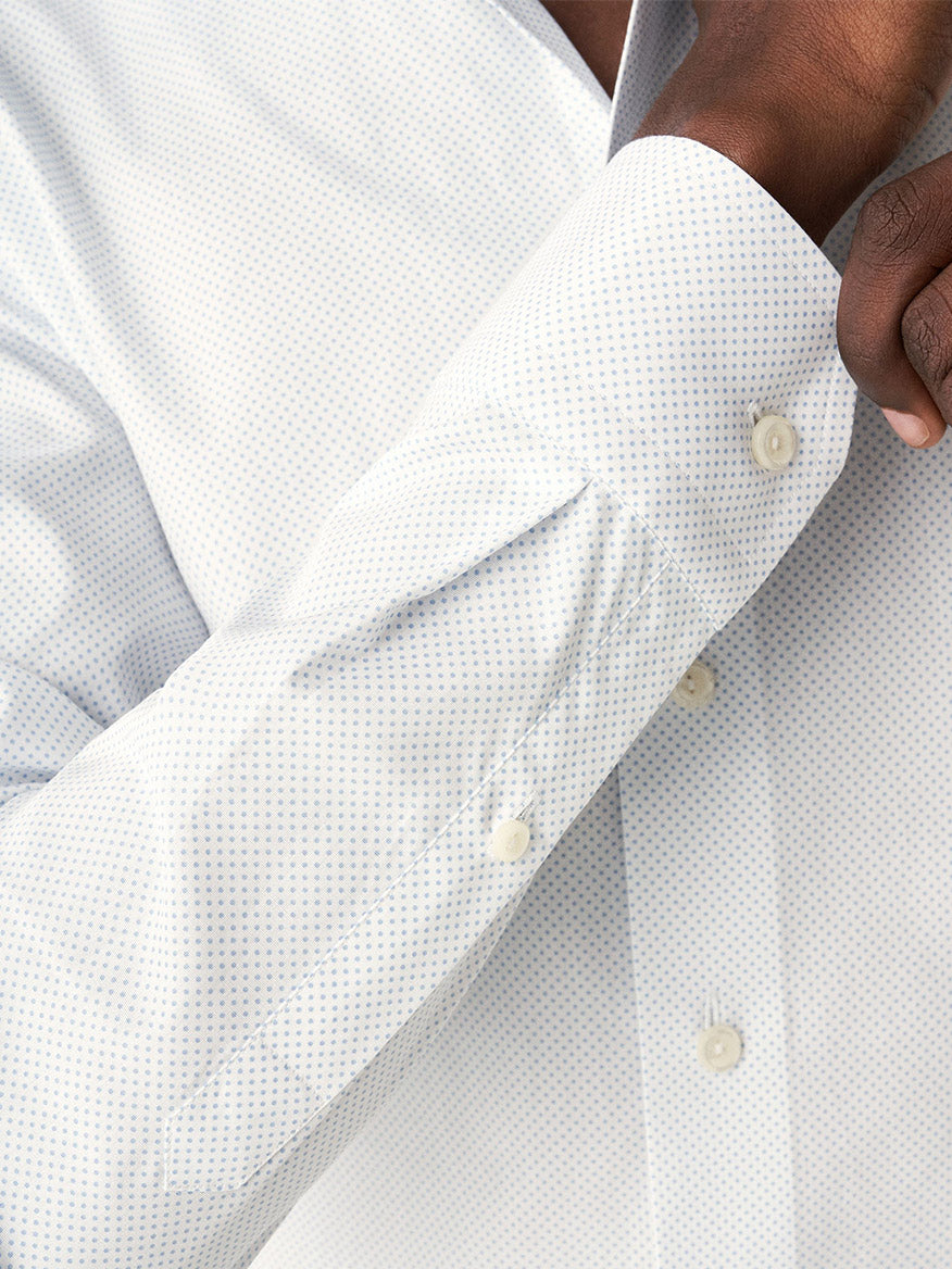 Close-up view of a person's arm in an Eton Light Blue Polka Dot Print Dress Shirt with button detail.