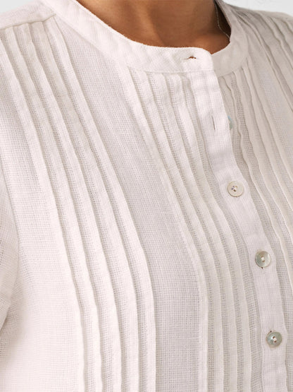 Close-up of a Faherty Brand Gemina Basketweave Dress in White with vertical pleats and visible buttons.