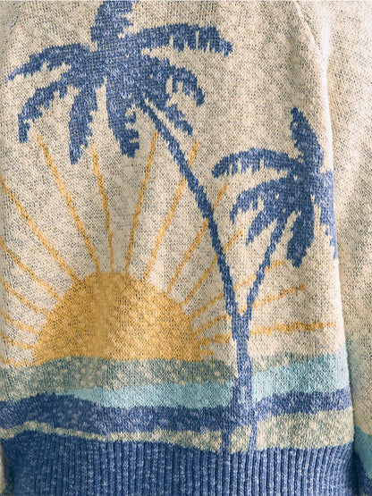Close-up of a Faherty Brand Island Time Cardigan in Coastal Capri with a tropical beach scene design featuring palm trees and a sun.