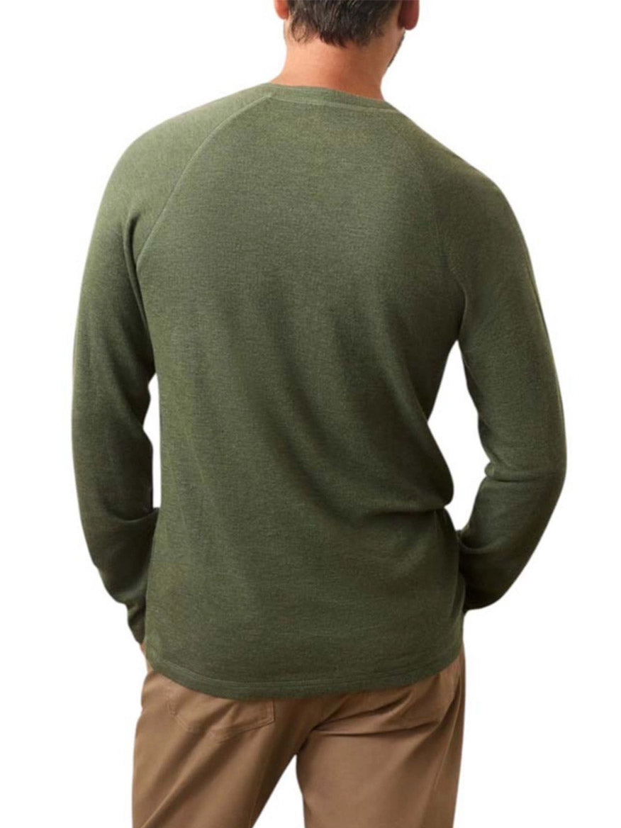 A man shown from the back against a white background wears the Faherty Brand Cloud Cotton Long-Sleeve Henley in Deep Fern Heather with khaki pants.