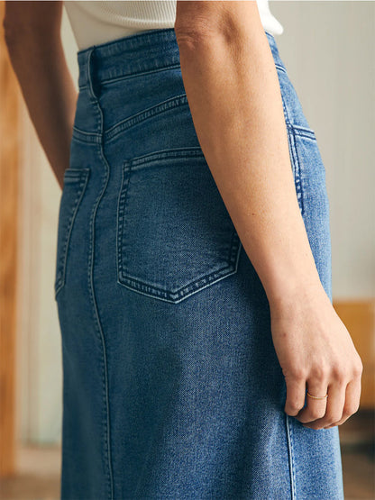 Woman wearing a Faherty Brand Stretch Terry Midi Skirt in Riverton Wash with a focus on the back pocket detail.