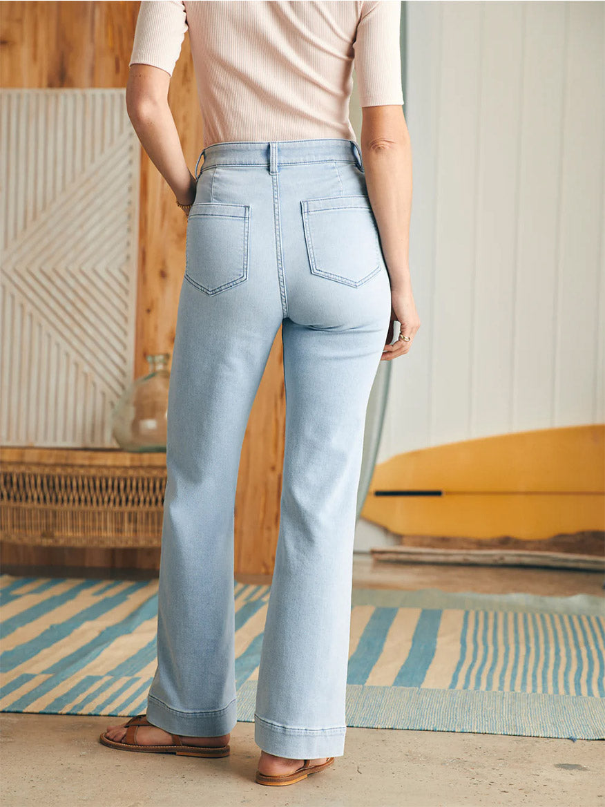 Woman standing with her back to the camera, showcasing Faherty Brand Stretch Terry Patch Pocket Pant in Clearlake designed with a high waist.