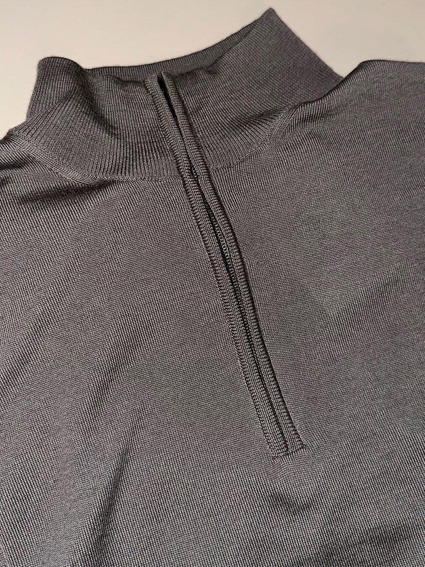 A close-up of the Filippo De Laurentiis Royal Merino Mock Quarter Zip in Taupe—a ribbed, gray Merino wool garment featuring a centered black zipper, shown partially unzipped.